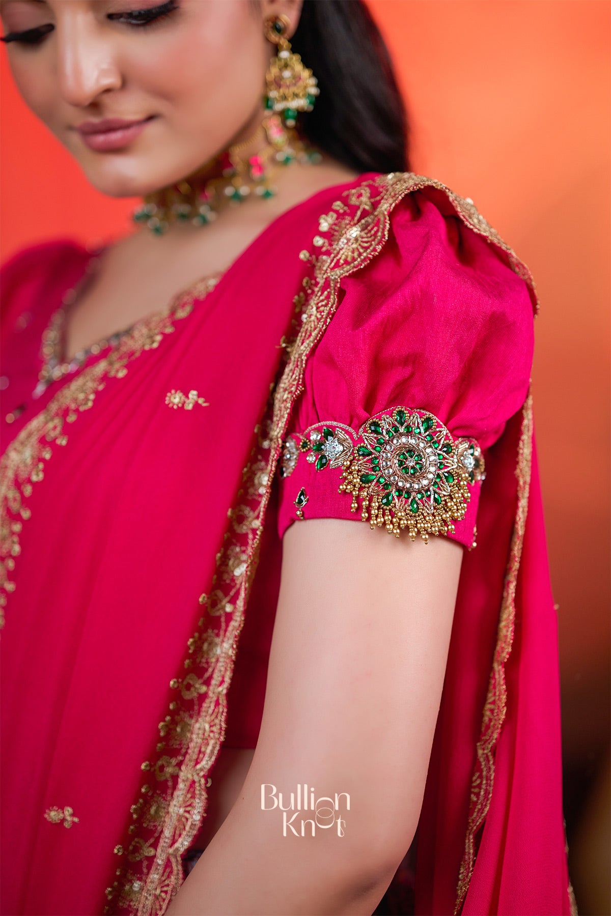 Close-up of Rithvika Banarasi Lehenga Set in Pink at bullionknot showcasing intricate embroidery and embellished sleeve detailing.