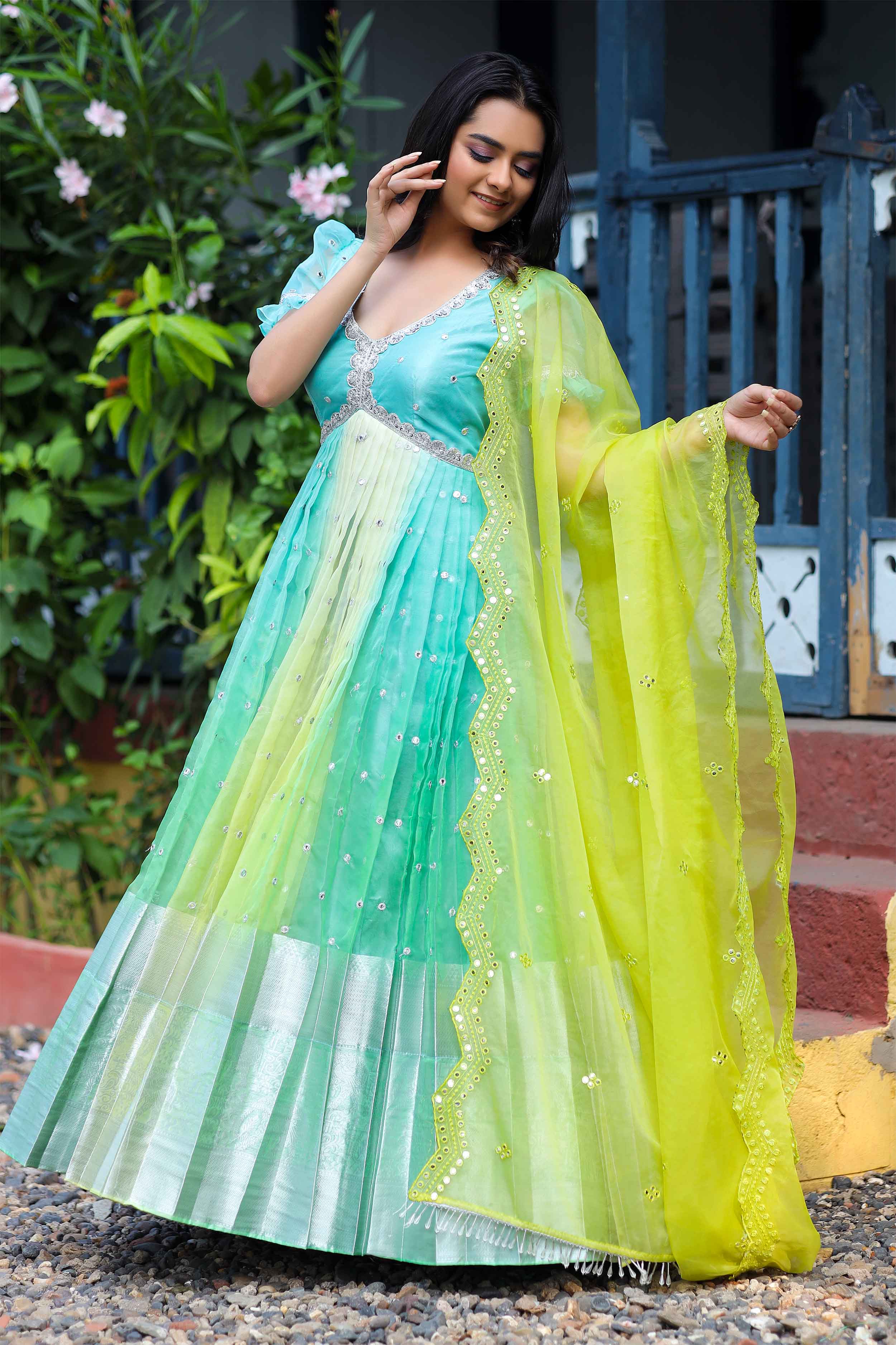 a woman in blue Anarkali dress with green dupatta