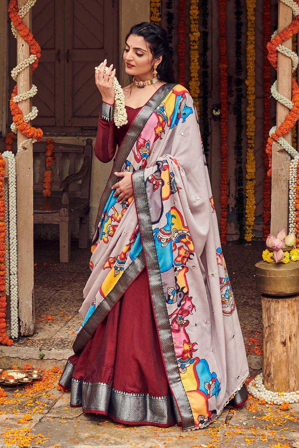 a model wore a Bullionknot's dark maroon handloom lehenga dress with cotton dupatta, dress name Shisha kalamkari Lehenga Set