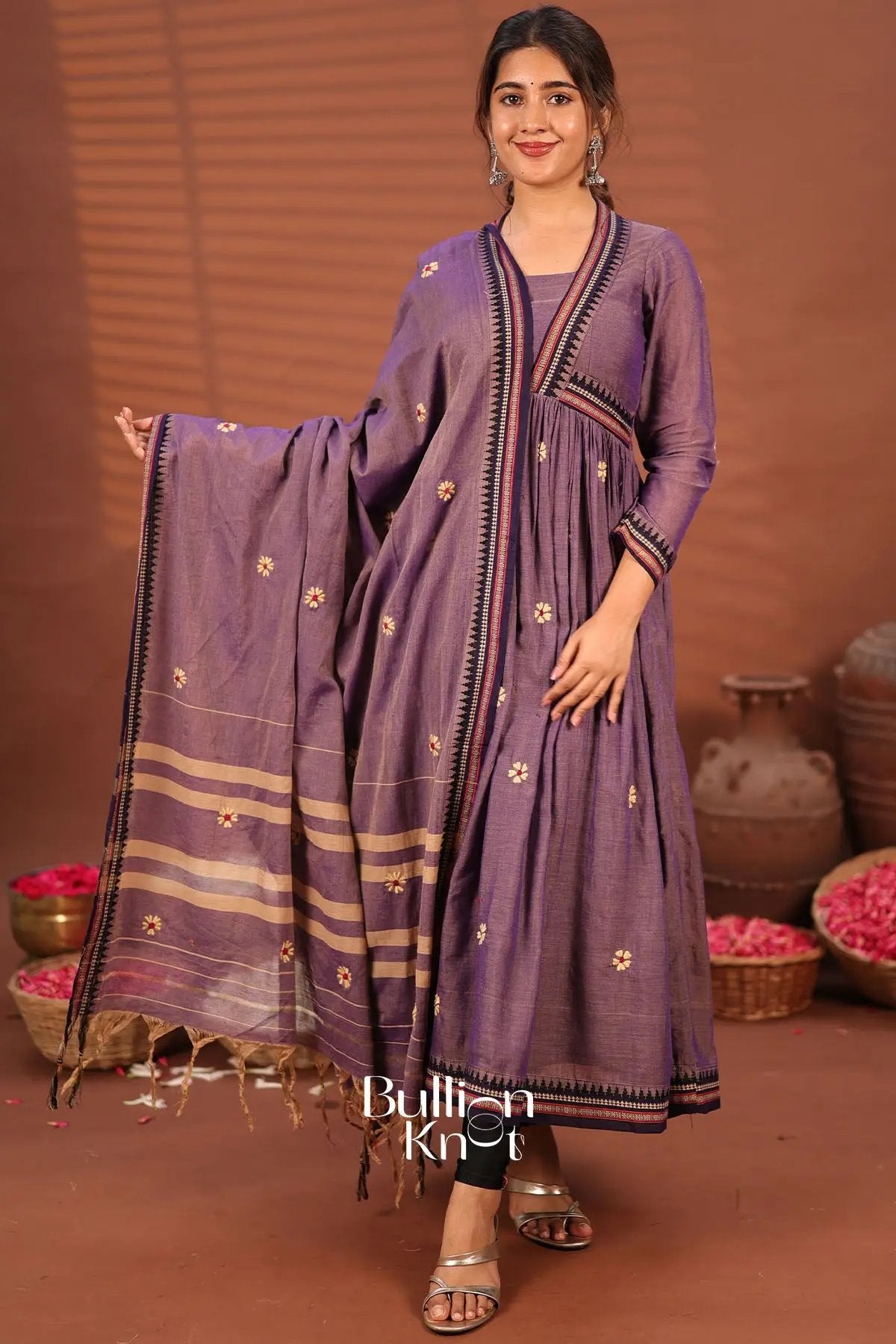 Model wearing purple handloom kurta set with earrings
