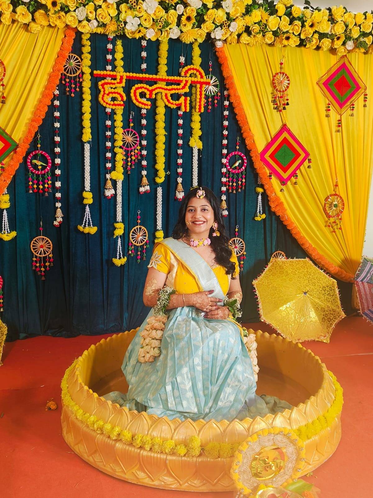 Woman in traditional attire sitting in a decorated chariot