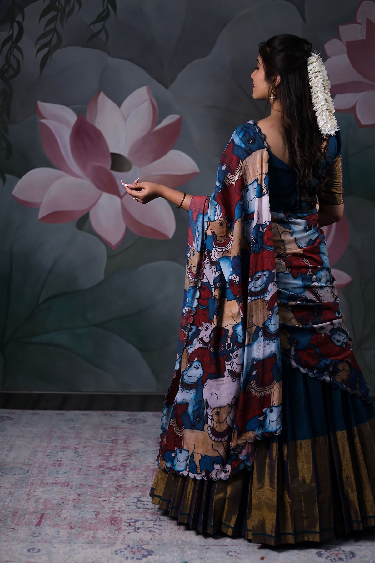 a women posing with dark blue Handloom Lehenga dress with cotton dupatta from Bullionknot