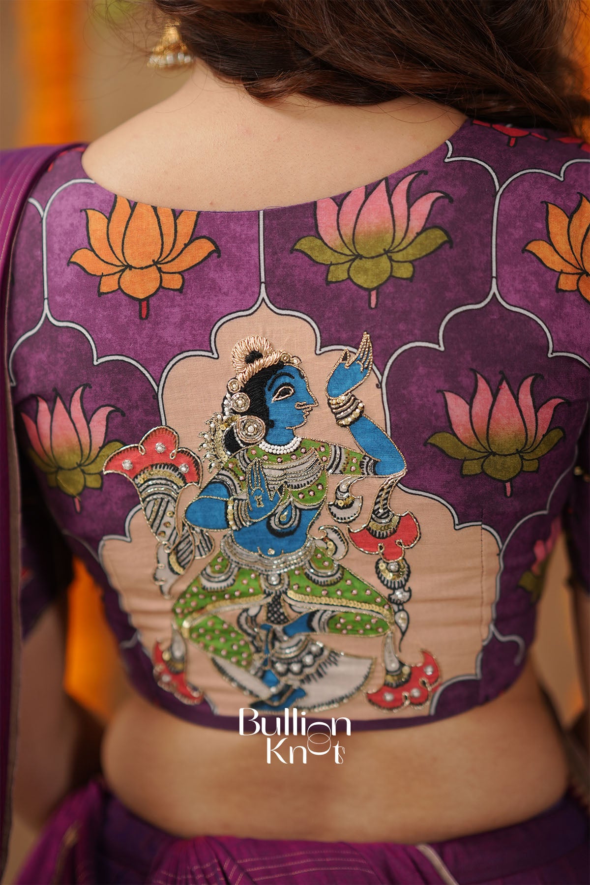 Purple blouse with intricate design of a deity and lotus flowers,