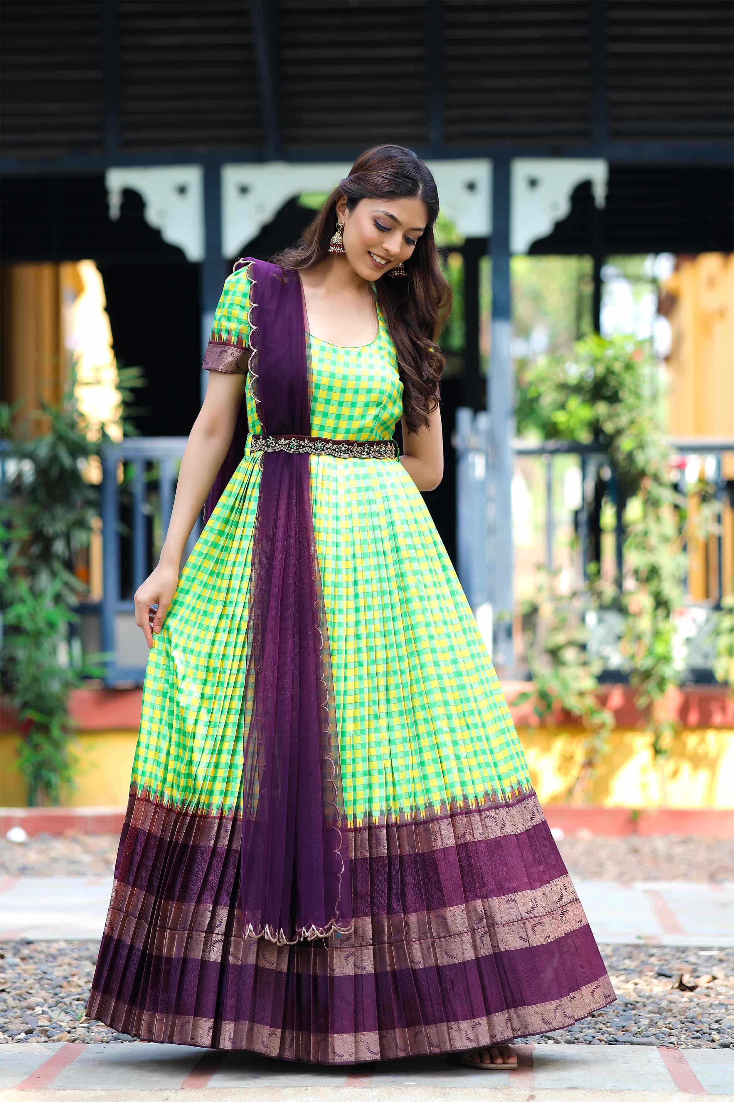 a woman in green pattu dress