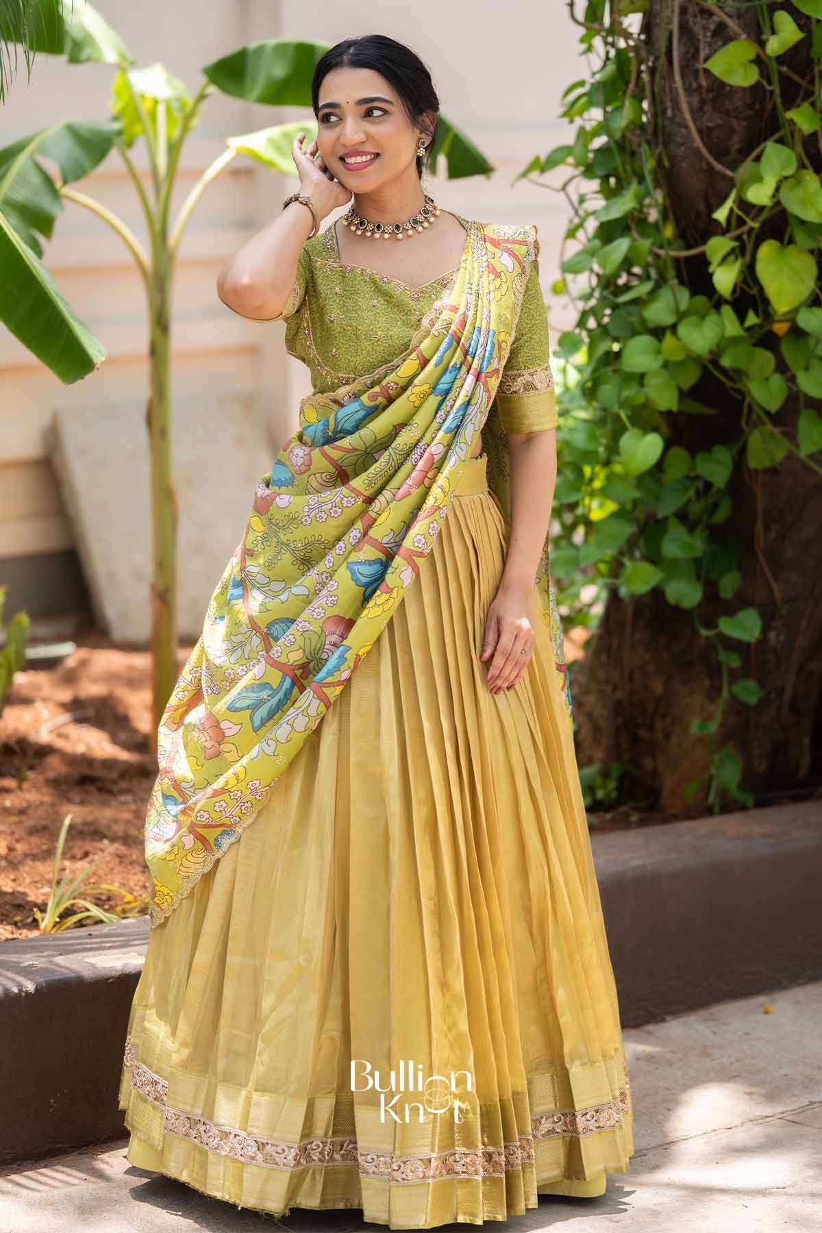 Elegant yellow traditional lehenga with floral printed dupatta, green embroidered blouse, and intricate border, perfect for festive occasions.