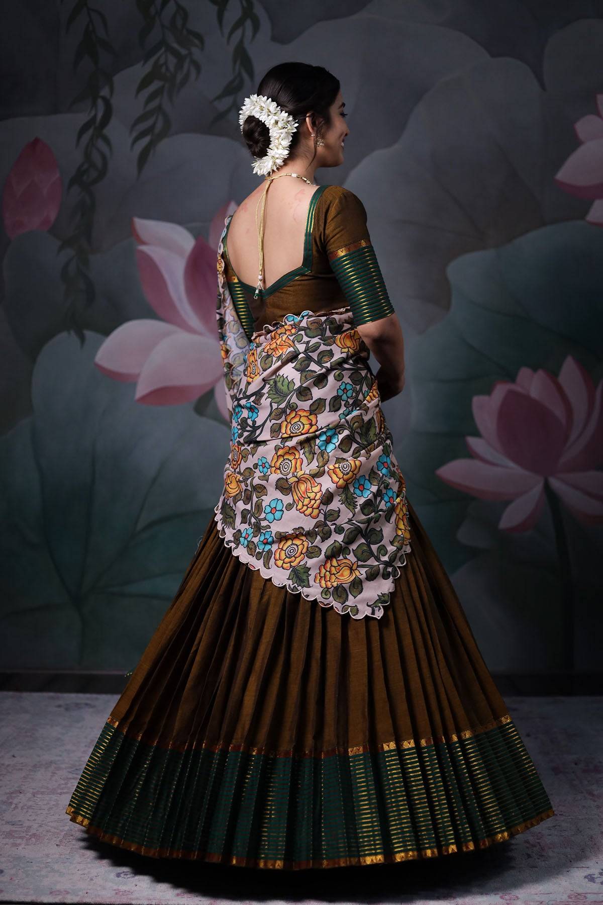 a woman in green half saree