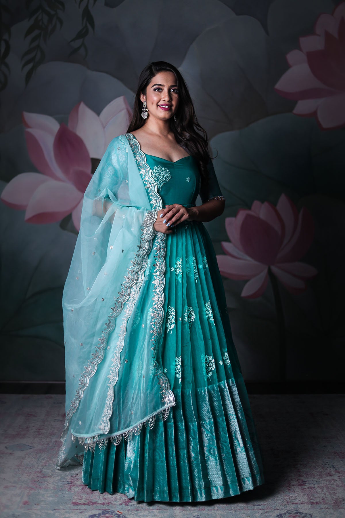 a woman in sea blue Anarkali dress