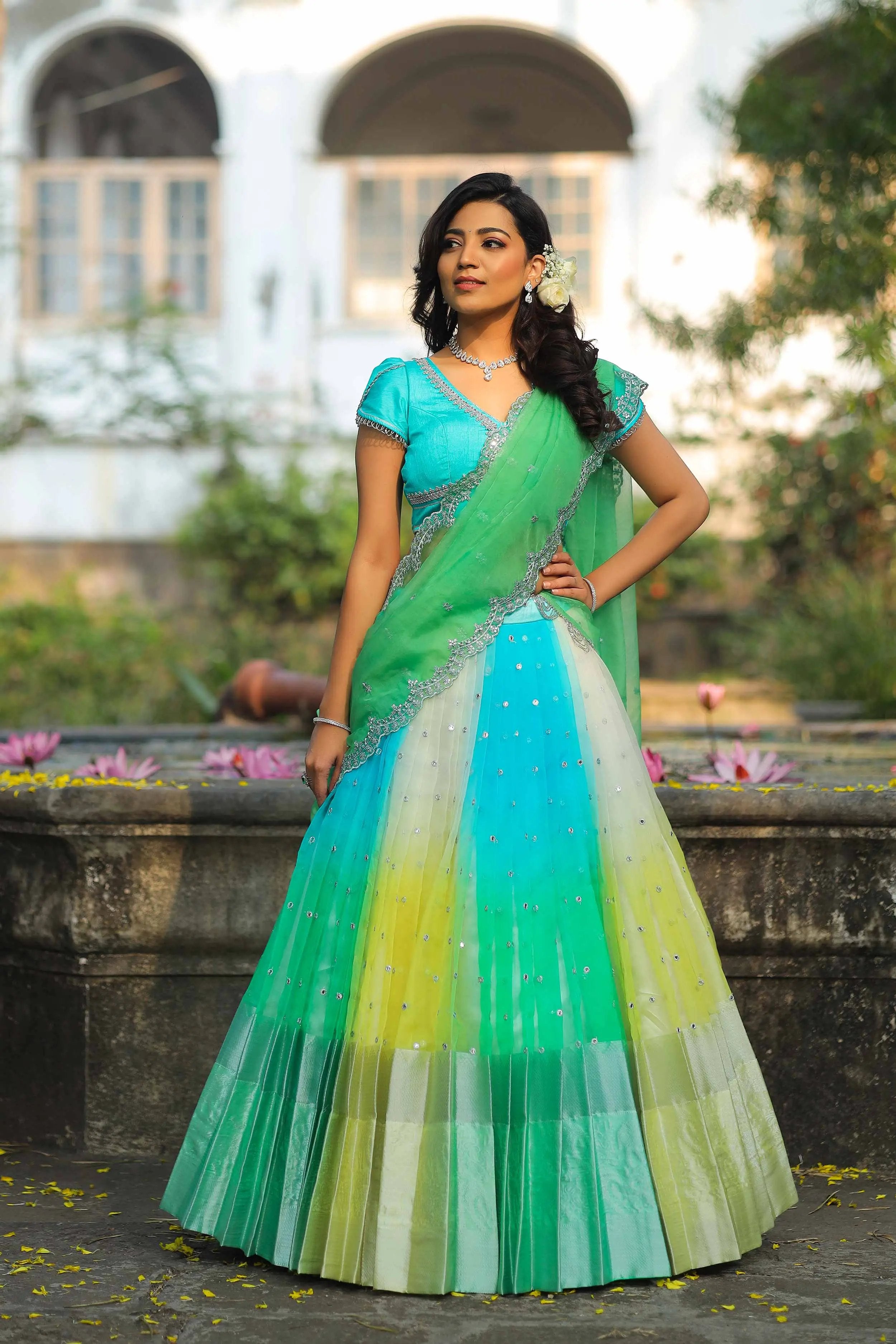 a woman in a green and blue Half Saree