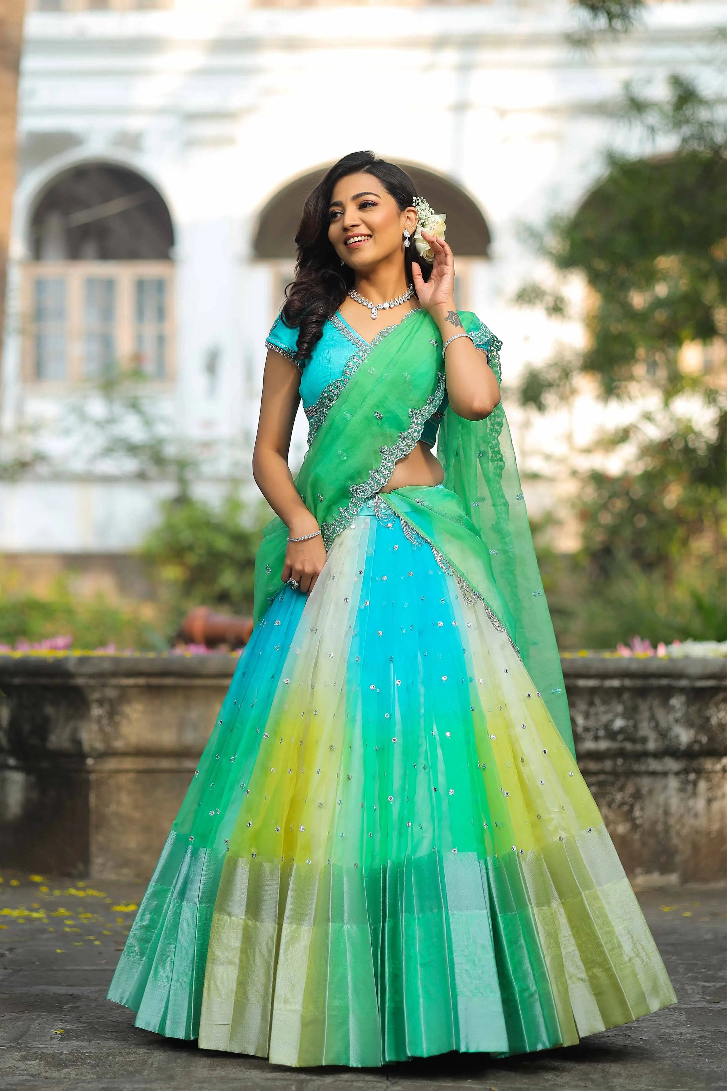 a woman in a green and blue lehenga