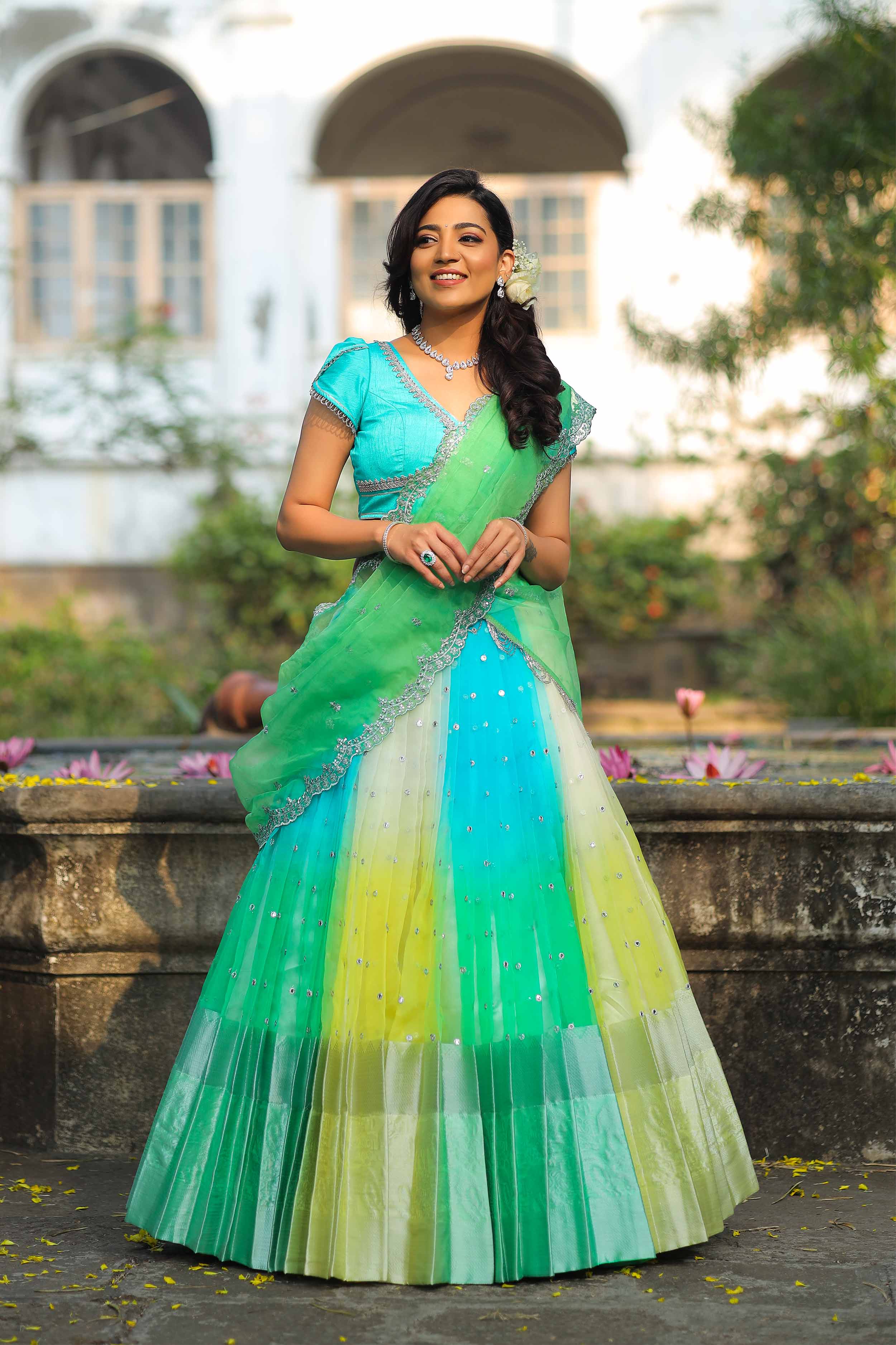 a woman in a green and blue dress