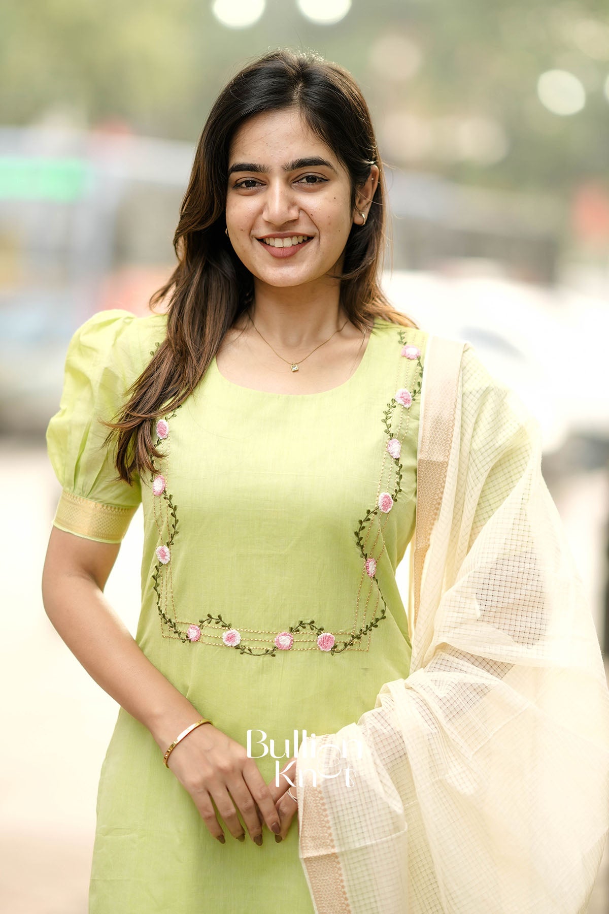 Woman in a light green traditional outfit 