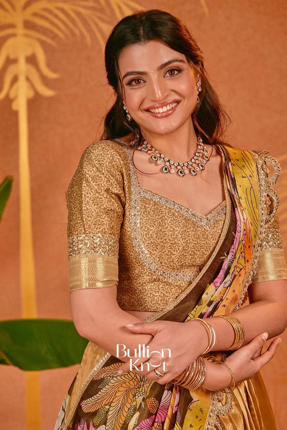 Model wearing golden silk lehenga with jewelry for festive occasion