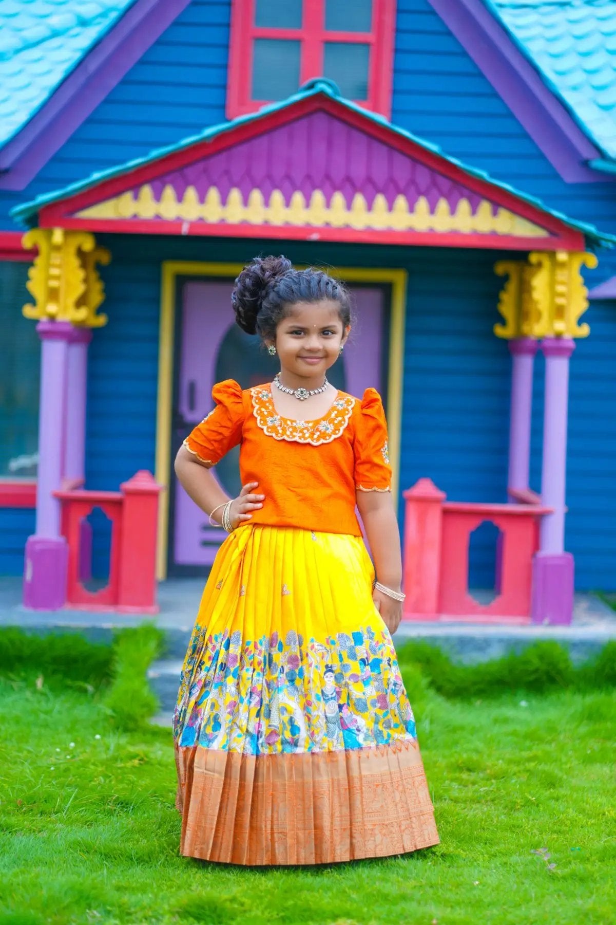 Young girl in traditional orange lehenga set outside