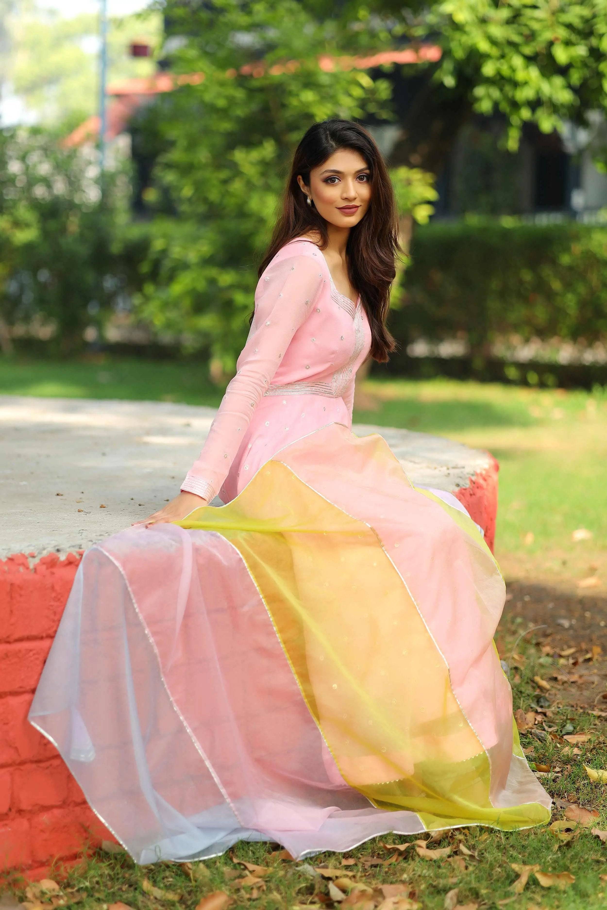 a woman in pink flamingo Anarkali suit set