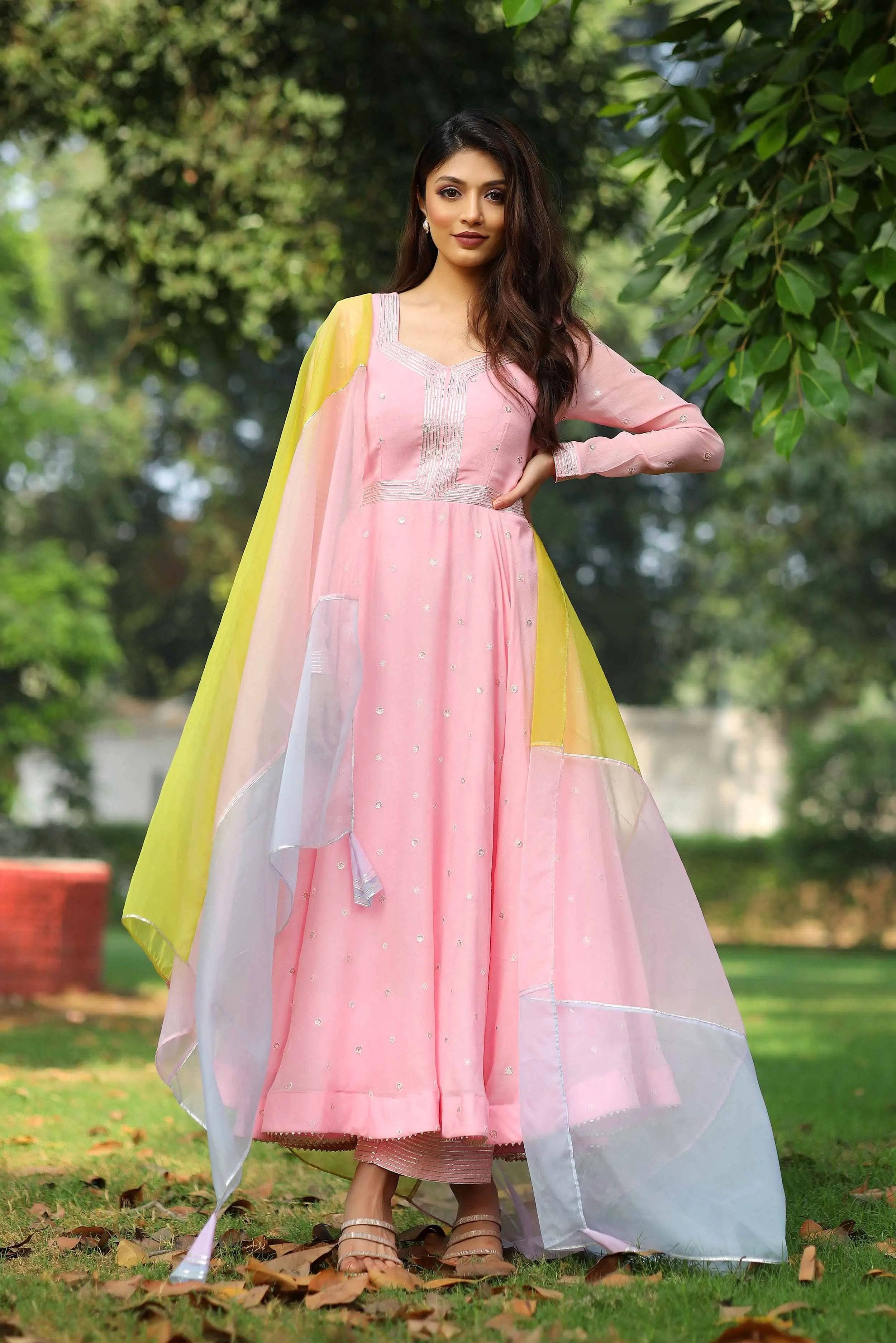 a woman in pink georgette dress with yellow organza dupatta