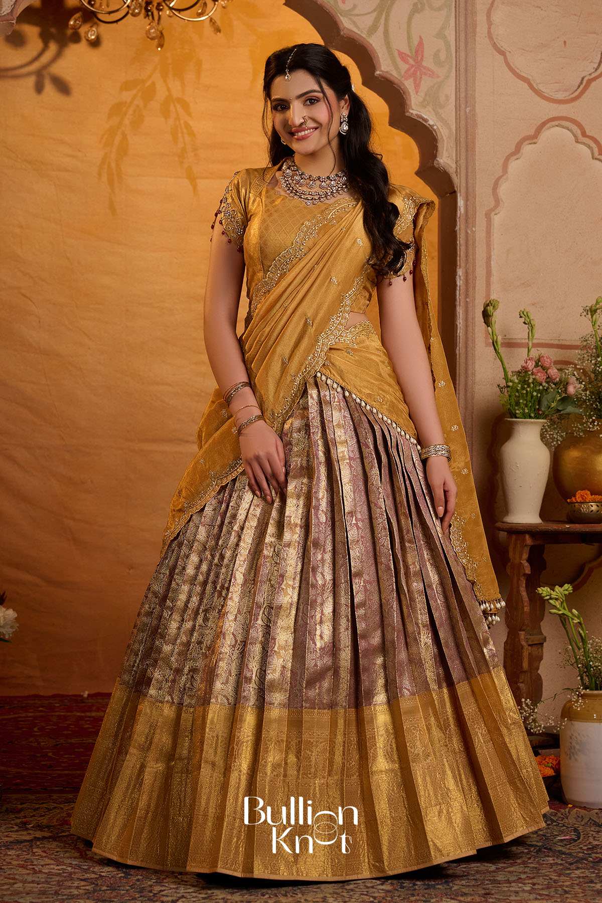 Elegant women in gold saree with jewelry and traditional decor background