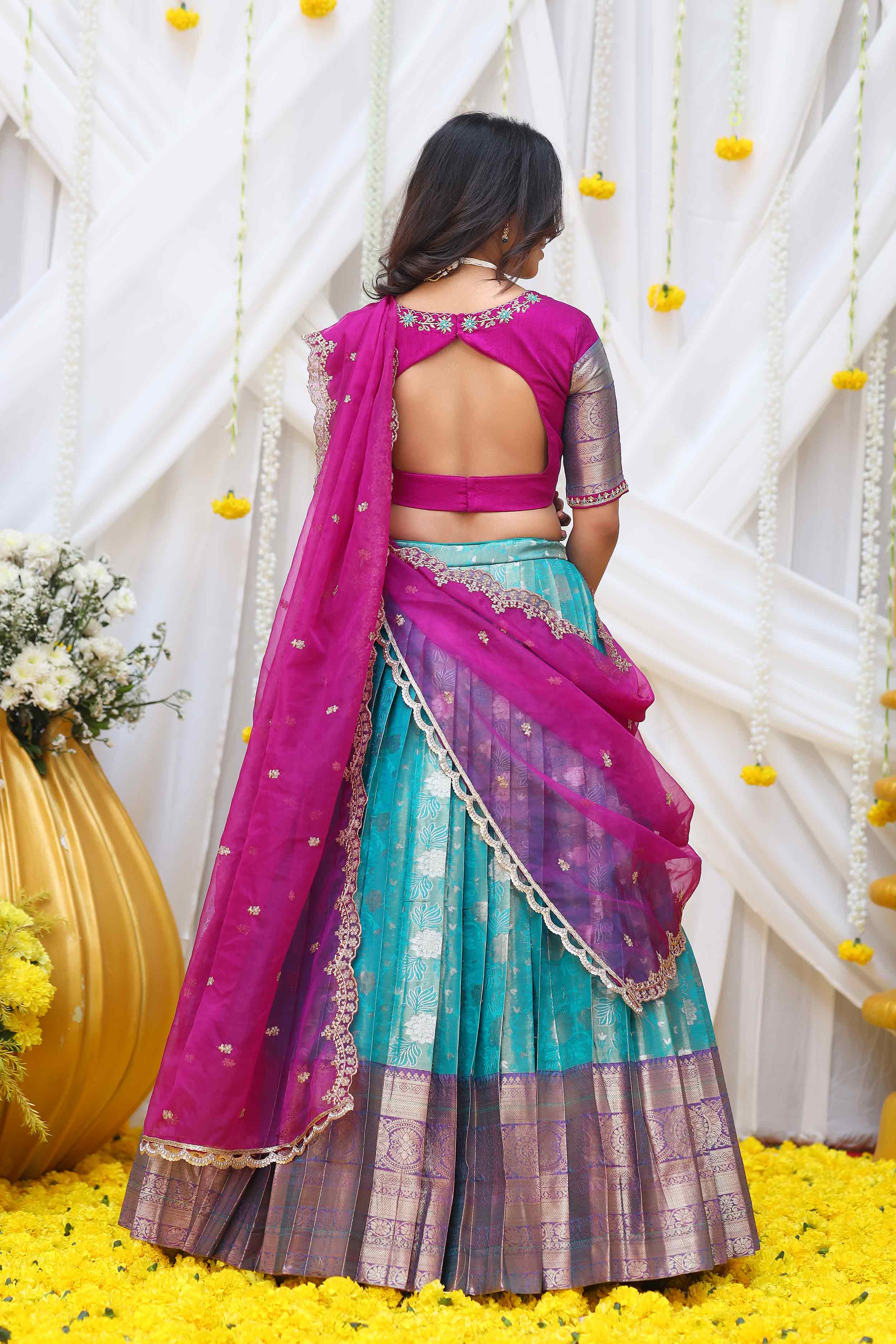 a woman in pink and blue lahenga set