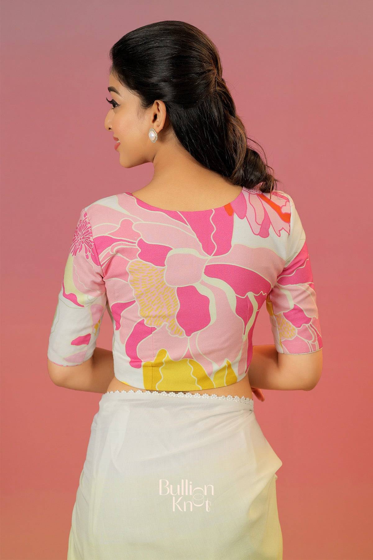 Woman wearing a floral blouse with a plain skirt against 