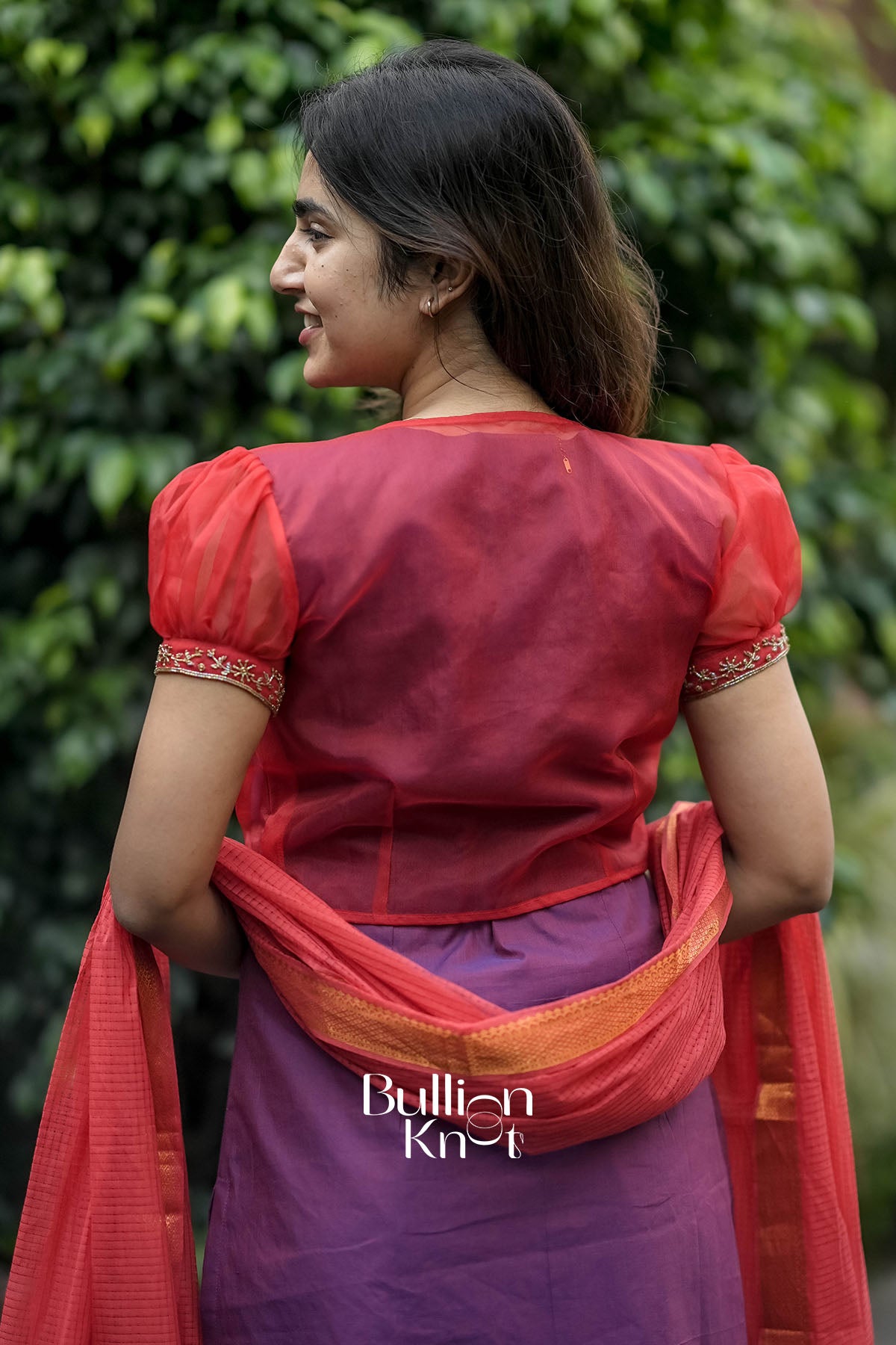 Back view of Mrinalika Suit Set showcasing organza jacket details