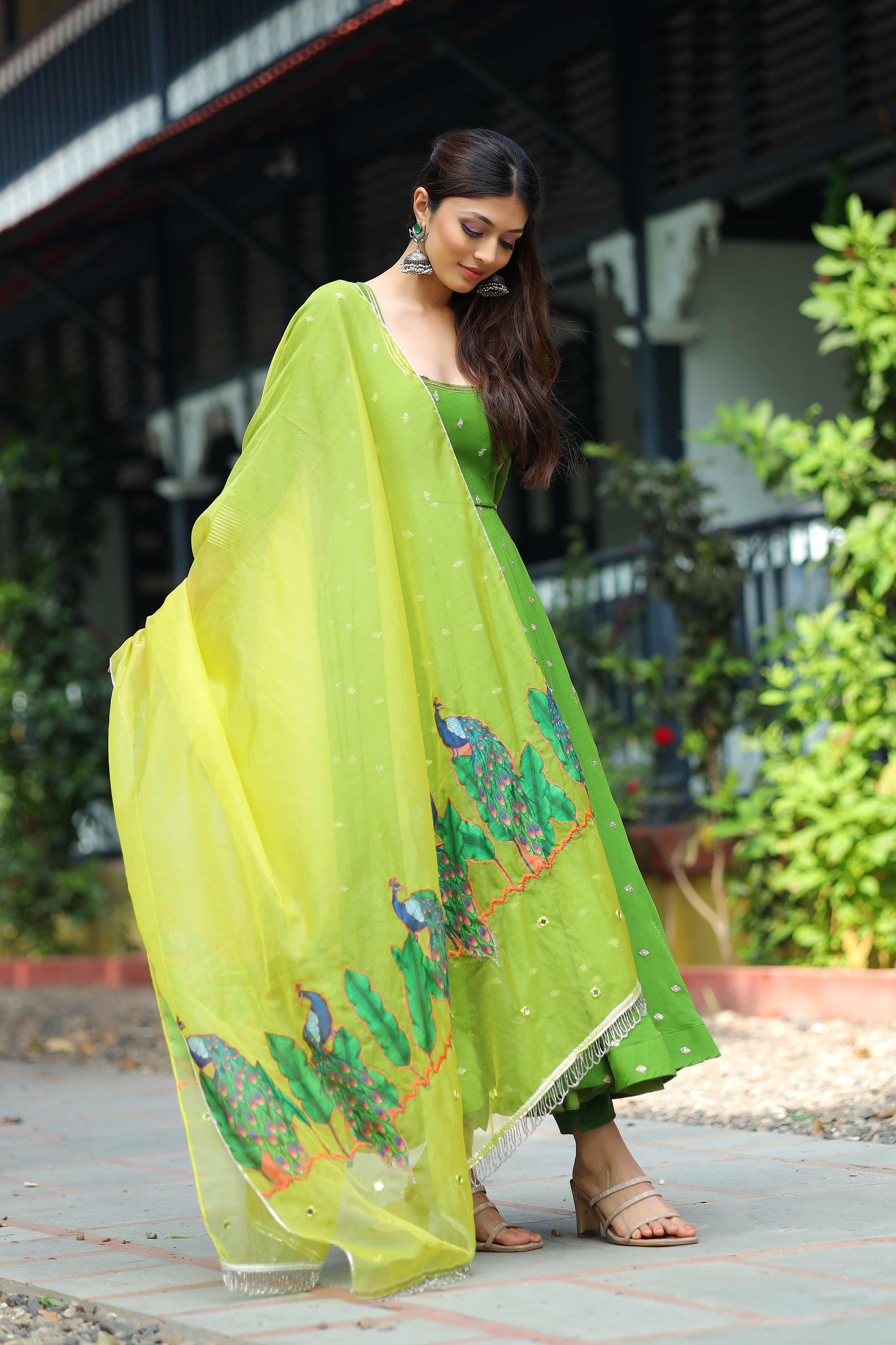 a woman in Green Pattu dress