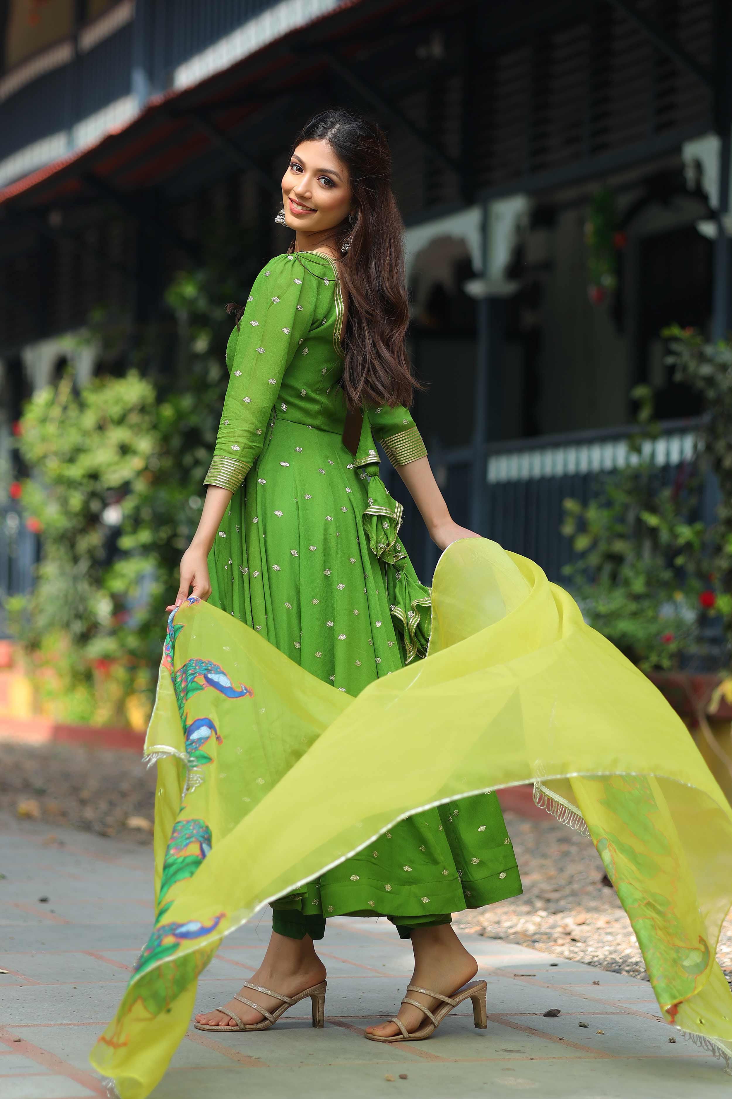 a woman in Green dress with yellow dupatta