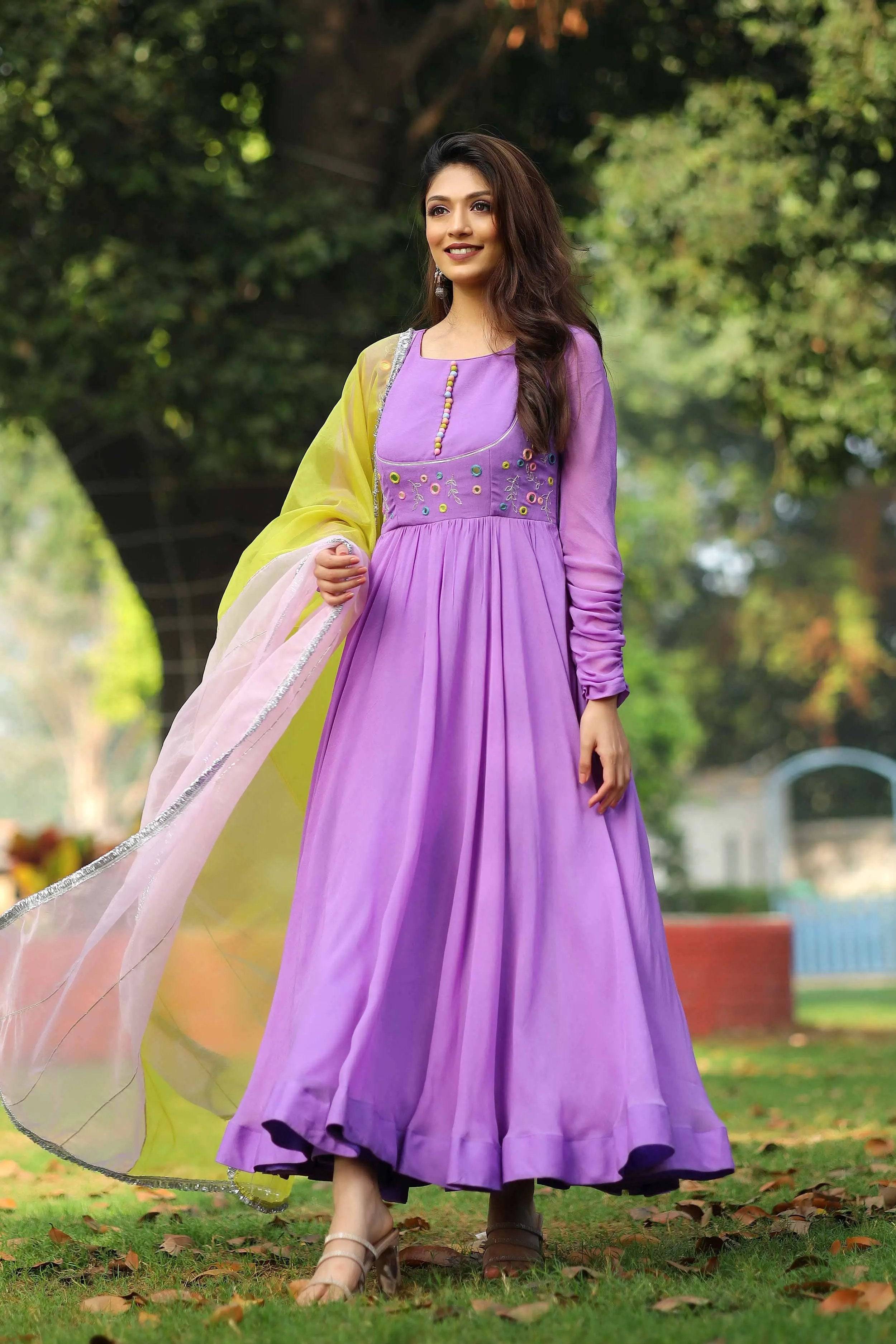 Lilac Anarkali suit with yellow dupatta in garden setting