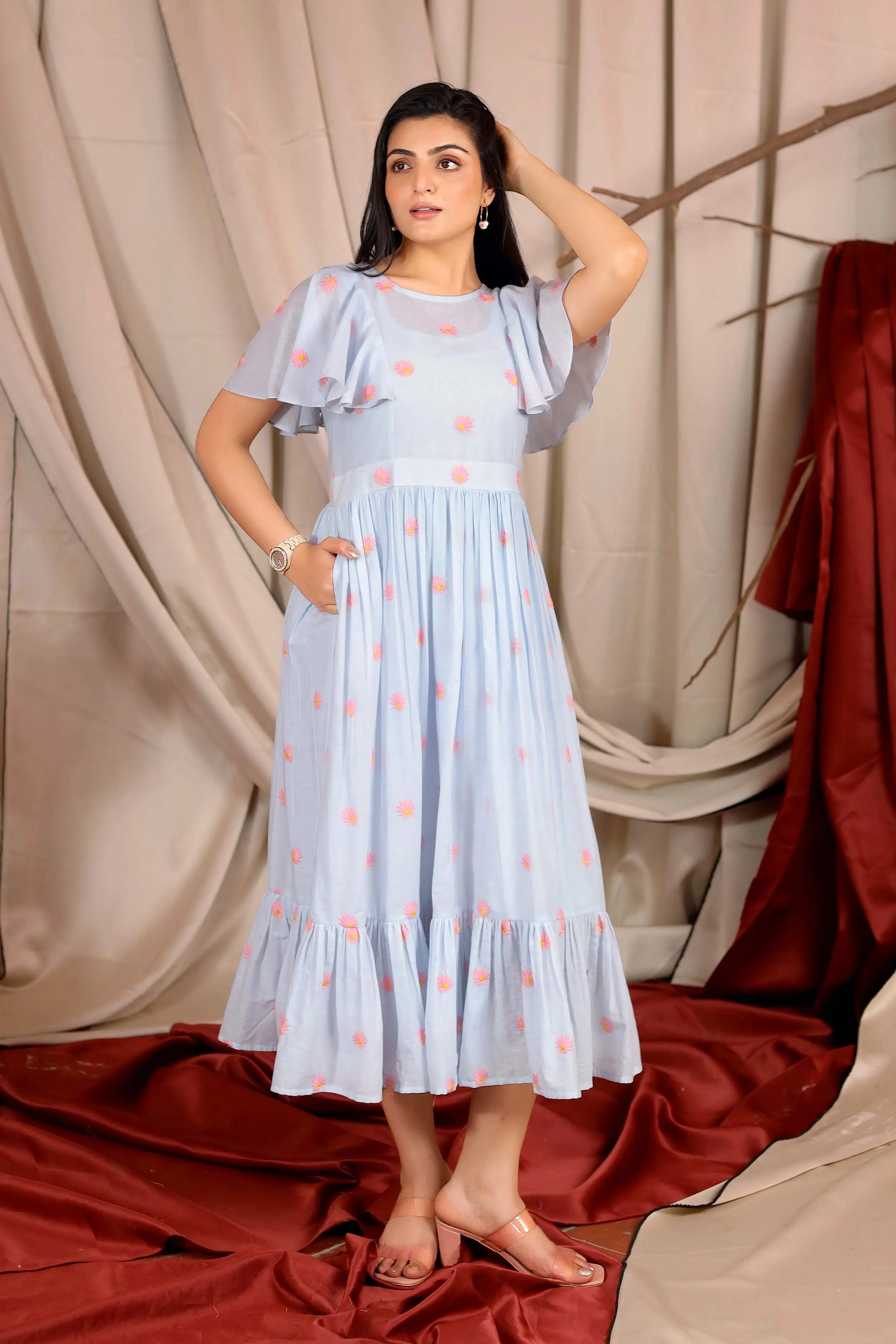 a woman in powder blue midi dress