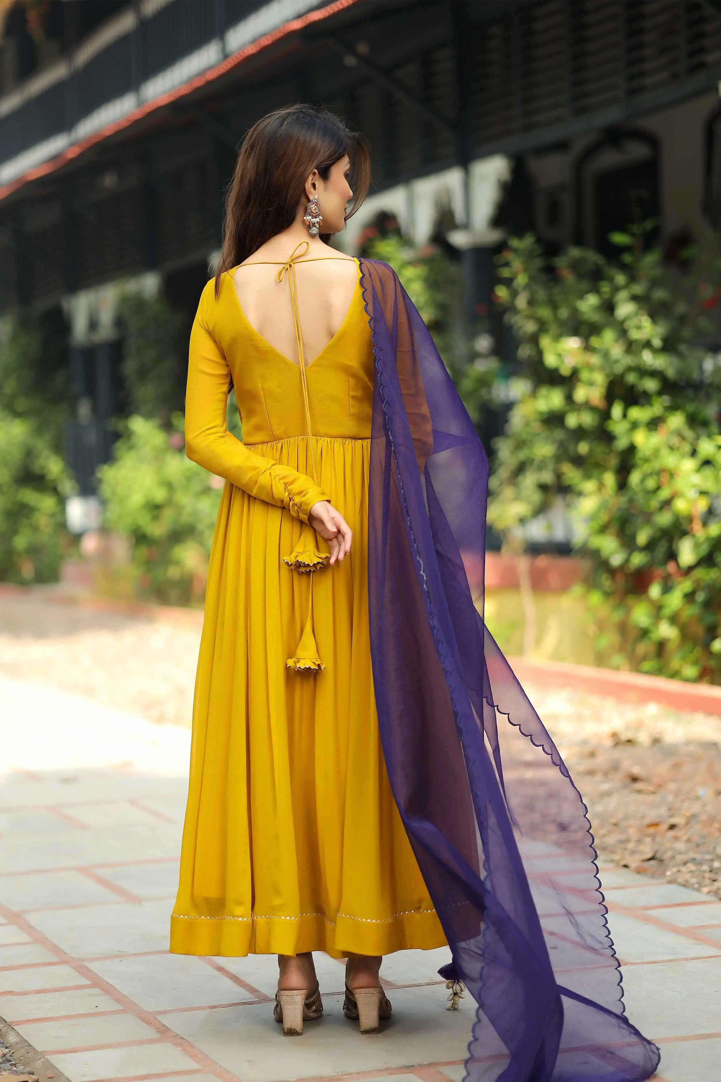A woman in yellow dress and blue dupatta 