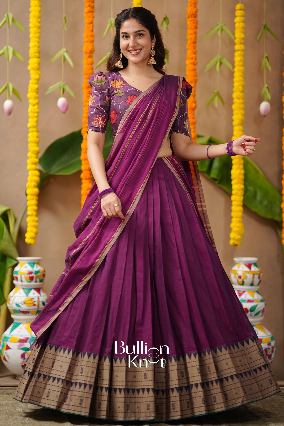 Woman wearing a purple saree 