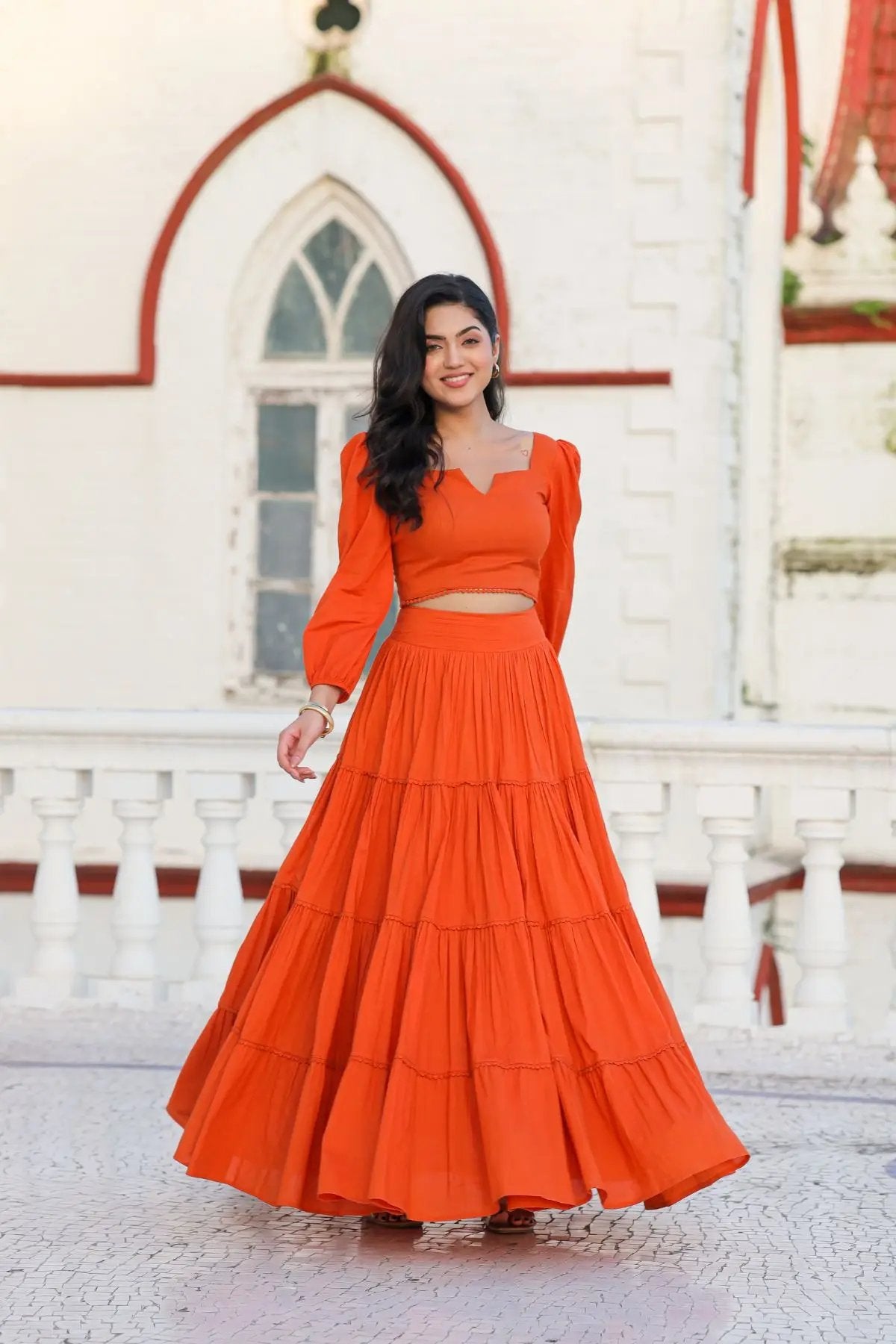 Flowy orange lehenga with fitted crop top