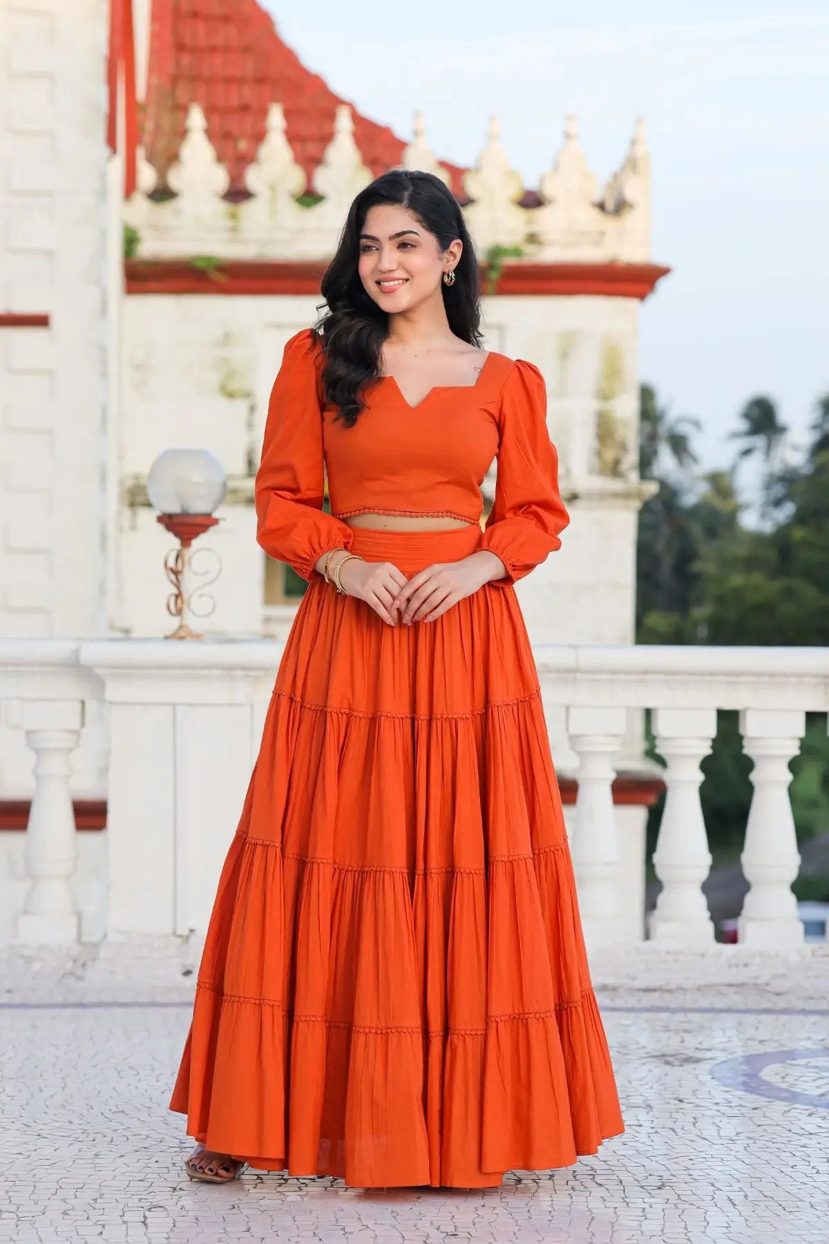 Stylish orange lehenga set with tiered skirt