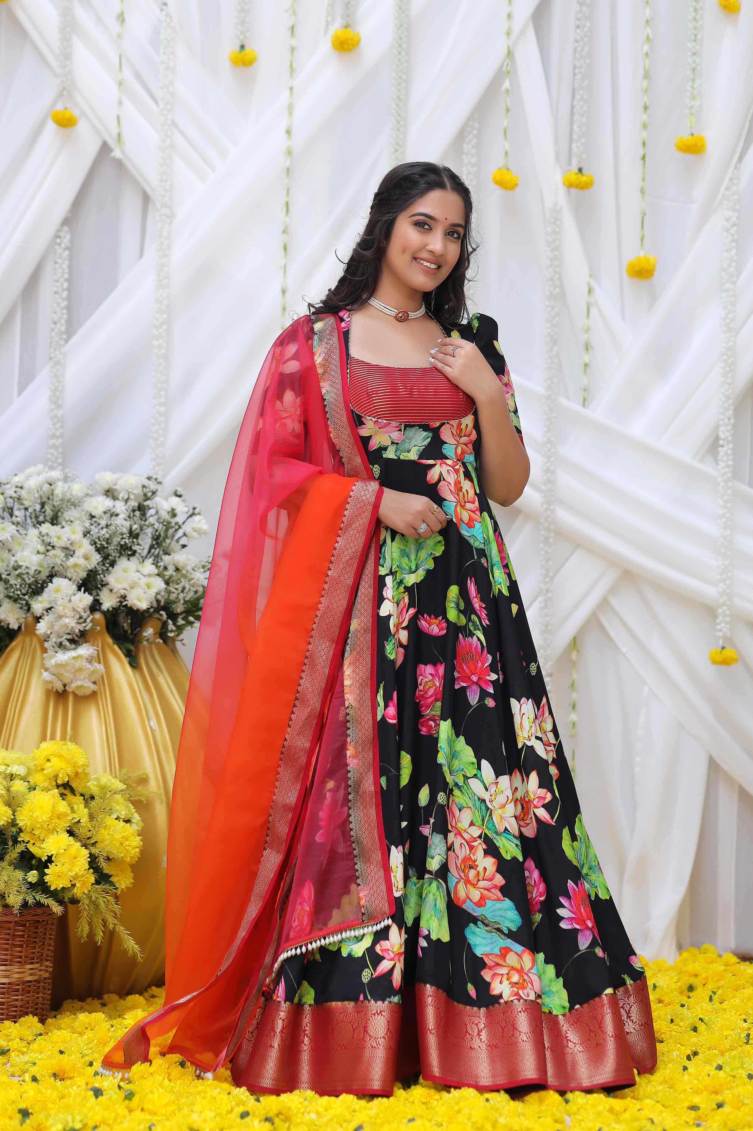 a woman in black and multi color banarsi dress